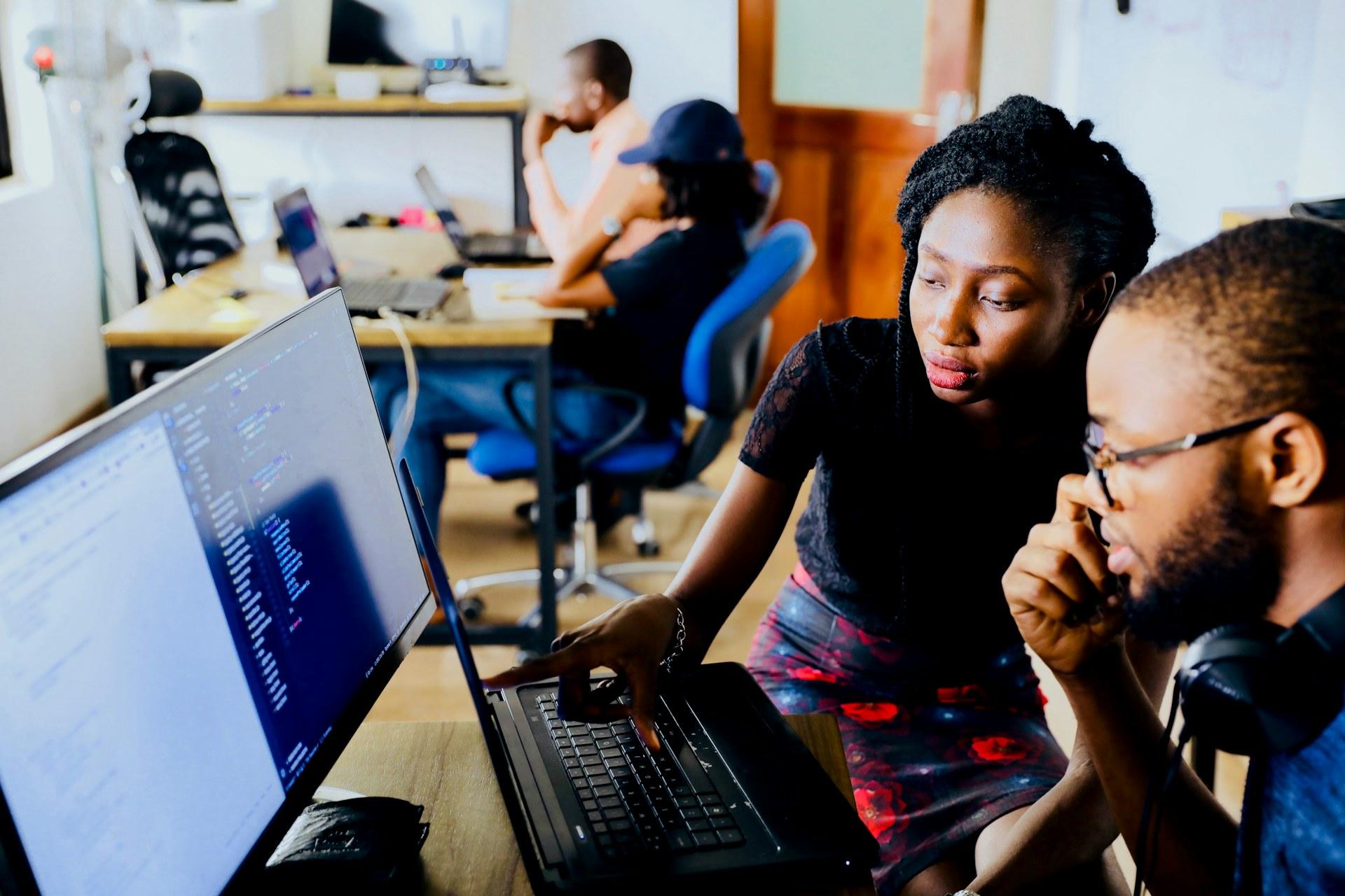 Engineers pair-programming on a live build at StudioByte Labs
